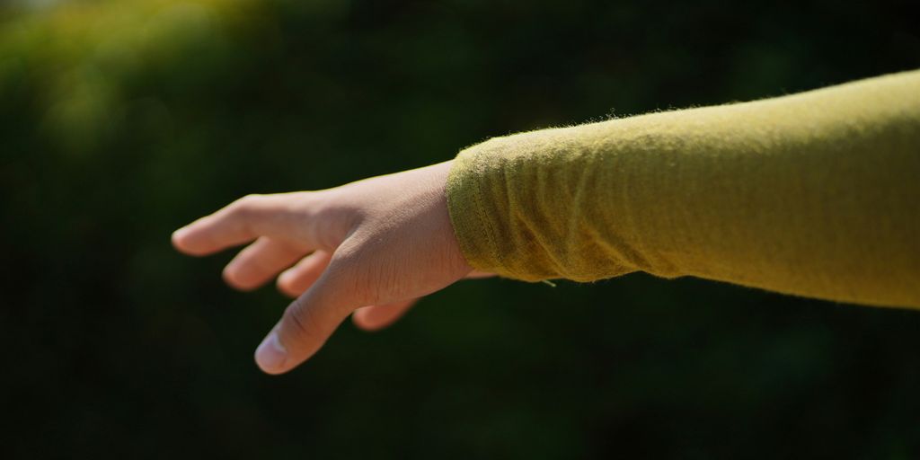 a person's hand reaching for something in the air