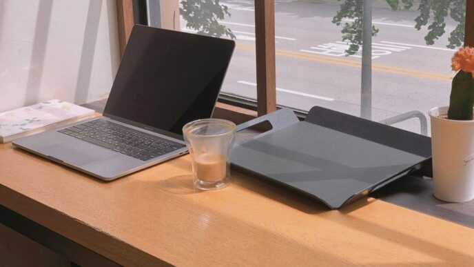 a laptop and a glass of water on a table