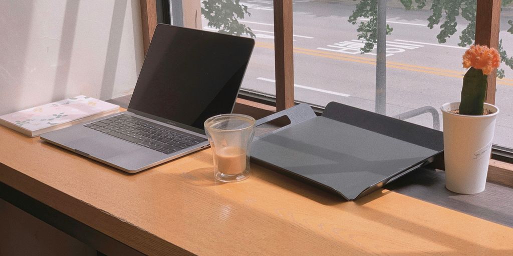 a laptop and a glass of water on a table