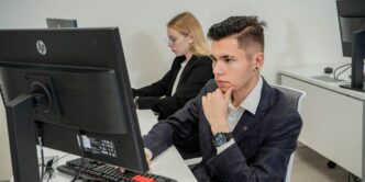 a man sitting at a desk in front of a computer