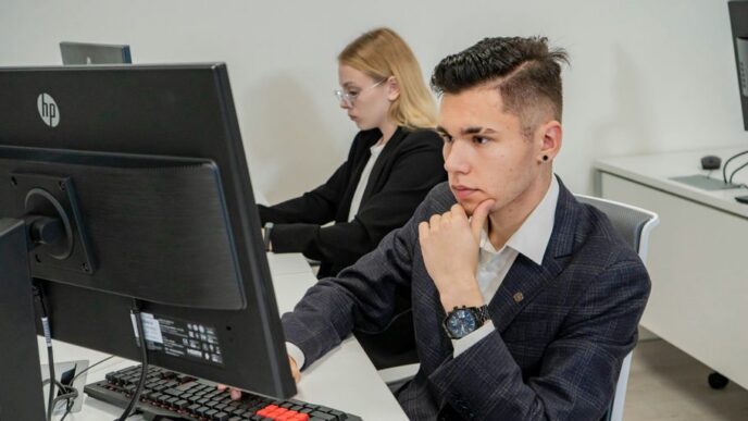 a man sitting at a desk in front of a computer
