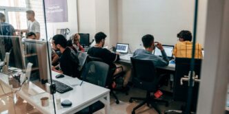 a group of people sitting at computers
