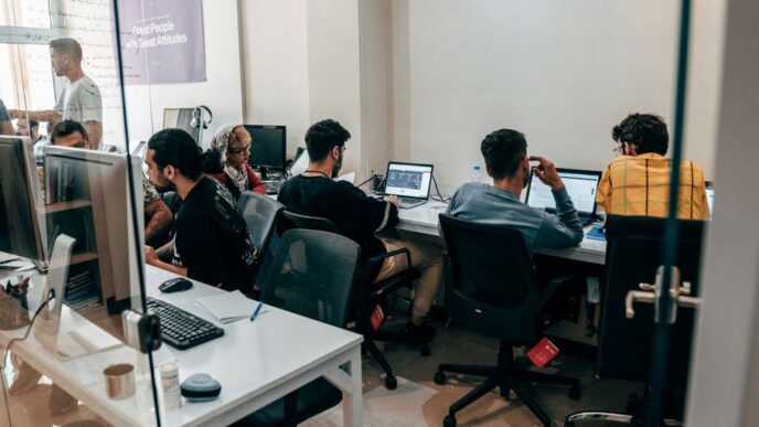 a group of people sitting at computers