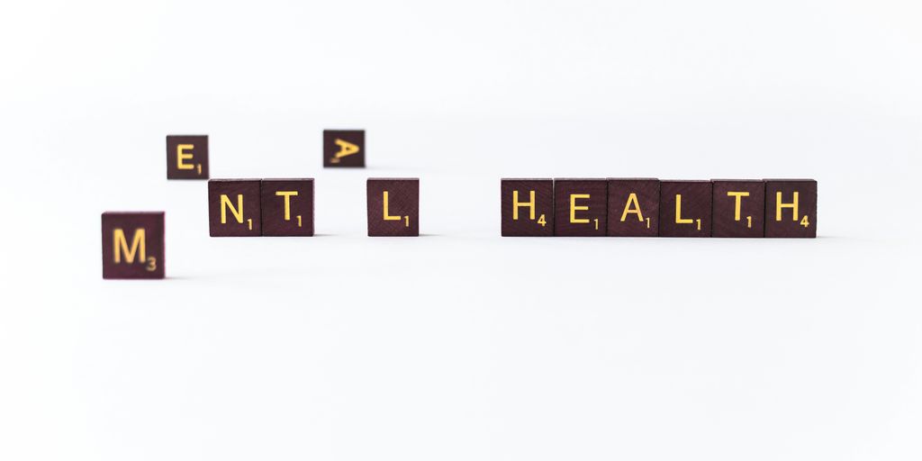 a set of wooden blocks spelling the word mental