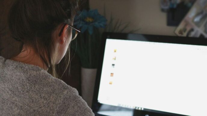 woman in front of computer monitor
