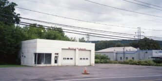 an empty parking lot with a fire hydrant in front of it