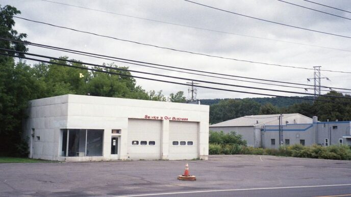 an empty parking lot with a fire hydrant in front of it