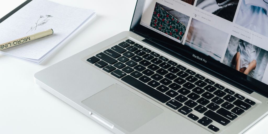 Macbook Pro besides white book