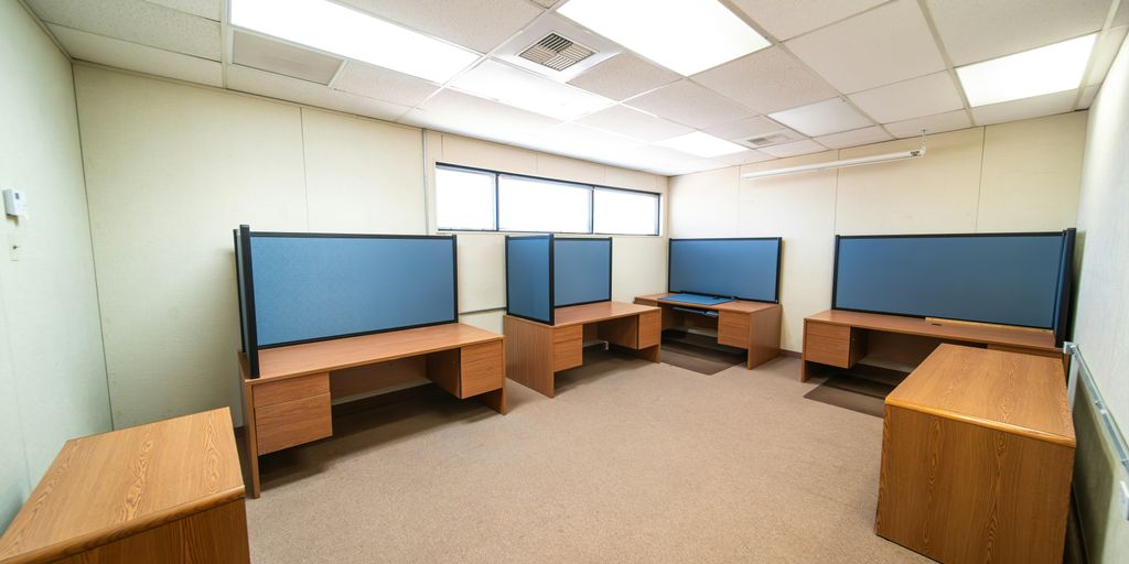 a room with a lot of desks and monitors