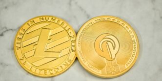 a close up of two gold coins on a marble surface