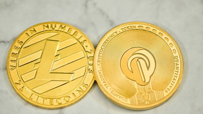 a close up of two gold coins on a marble surface