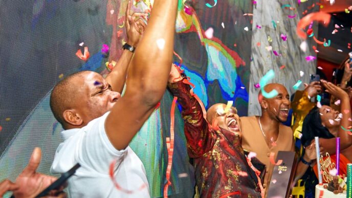 A man in a white shirt is throwing confetti