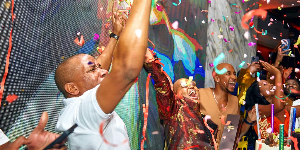A man in a white shirt is throwing confetti