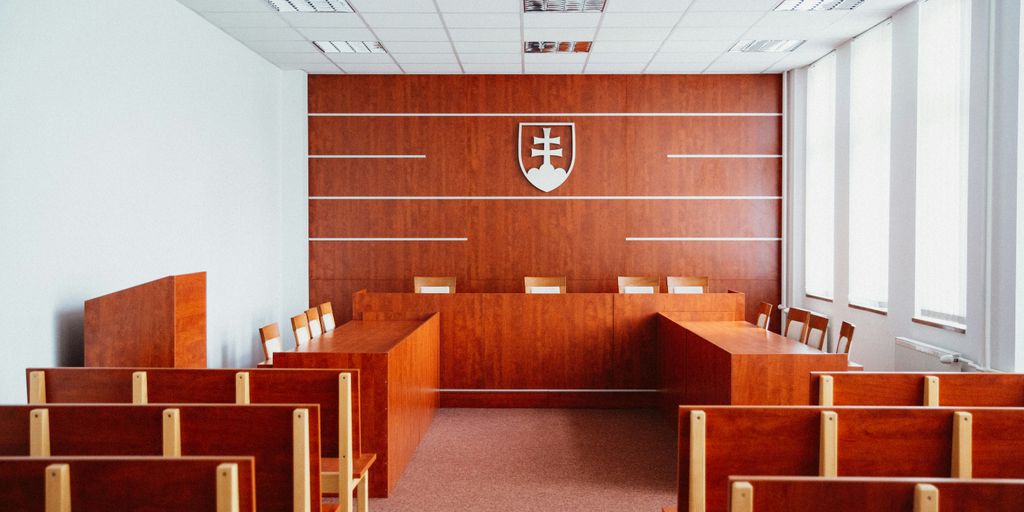 a room filled with wooden desks and chairs