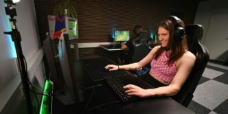 A woman sitting at a desk with headphones on
