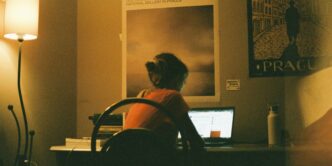 woman in red and black stripe shirt sitting on chair