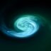 a green and blue swirl in the dark