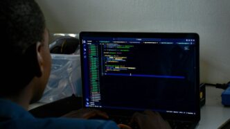 a man sitting in front of a laptop computer