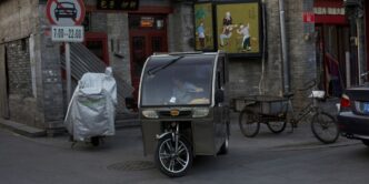 a baby stroller parked on the side of a street