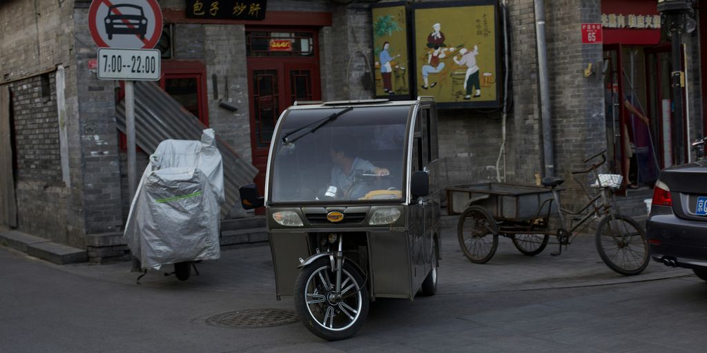 a baby stroller parked on the side of a street