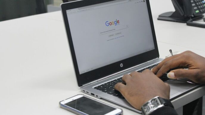 person typing on gray and black HP laptop