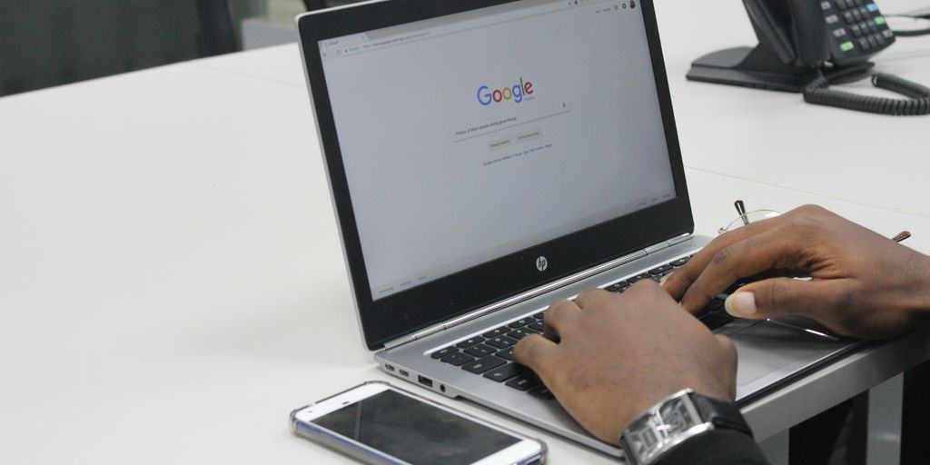 person typing on gray and black HP laptop