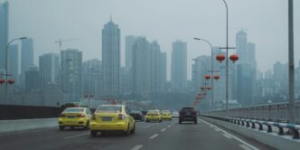 cars on road near city buildings during daytime