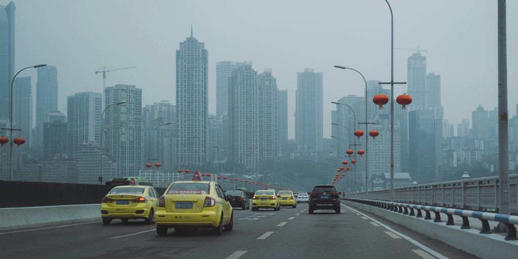 cars on road near city buildings during daytime