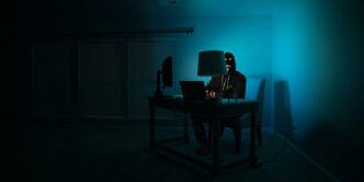a person sitting at a desk in a dark room