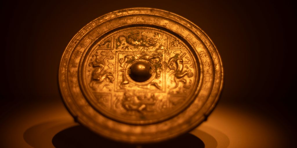 An ornate, ancient chinese bronze mirror.