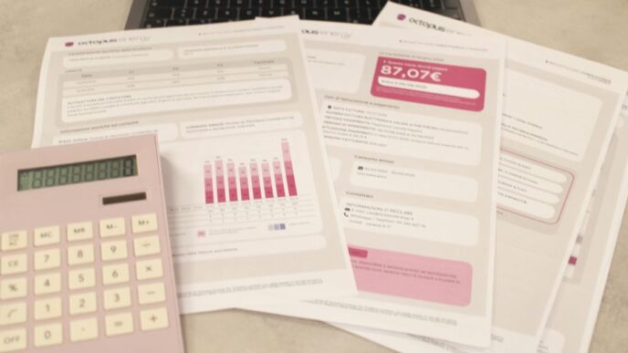 Bills, calculator, and a laptop: financial tasks underway.