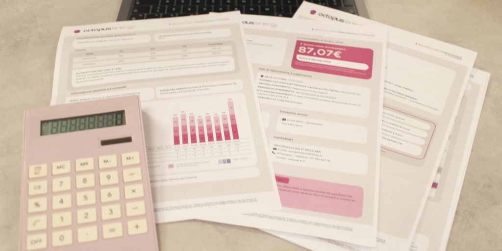 Bills, calculator, and a laptop: financial tasks underway.
