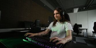 A woman sitting at a desk with a keyboard and mouse