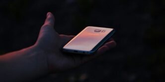a person holding a cell phone in their hand