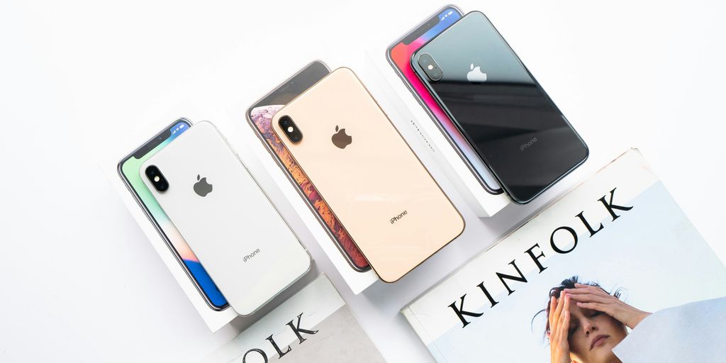 three assorted-color of iPhone Xs on boxes