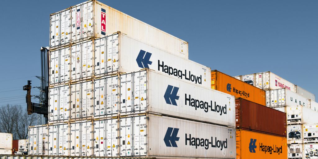 Shipping containers are stacked in a large pile.