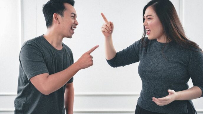 man in gray crew neck long sleeve shirt standing beside woman in black crew neck shirt