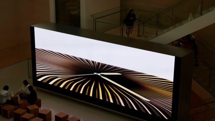 Large screen displays abstract graphic art.