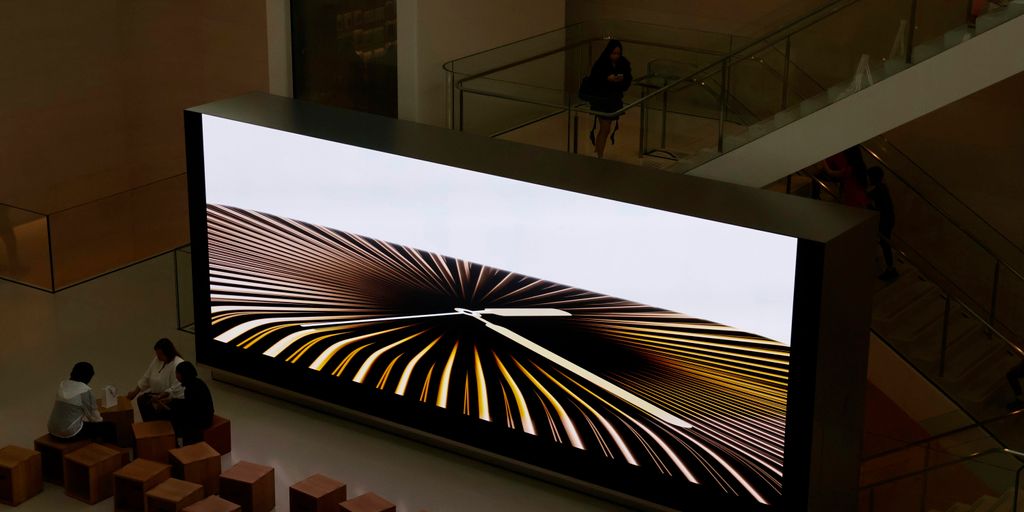 Large screen displays abstract graphic art.