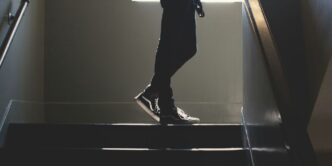 person standing on in a dim-lit stair