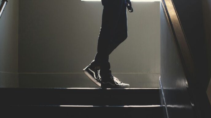 person standing on in a dim-lit stair