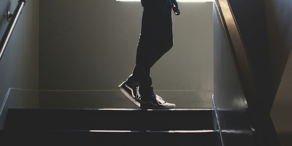 person standing on in a dim-lit stair