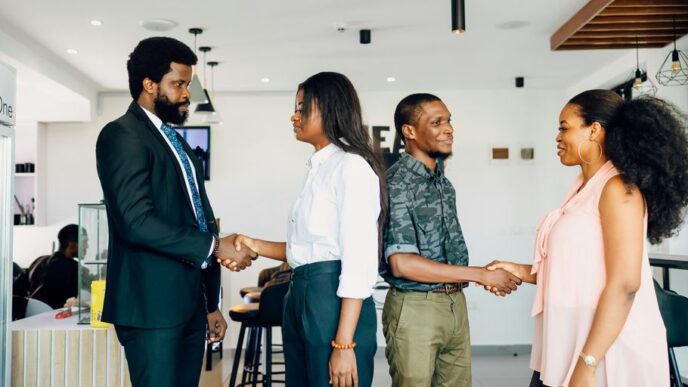 A group of people shaking hands in a room
