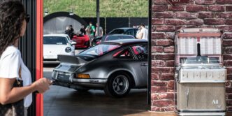 a woman walking past a car parked in a garage