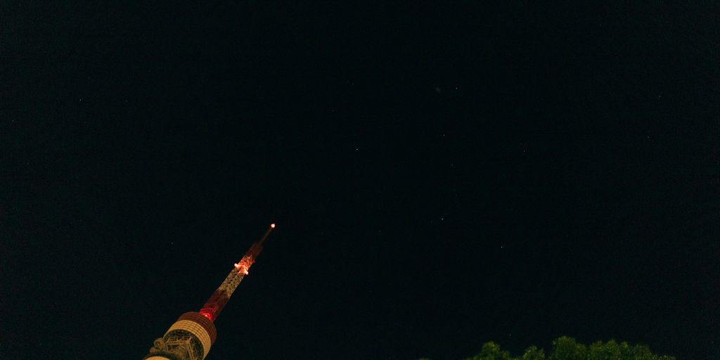 A very tall tower with a clock on it's side