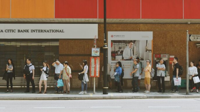 people fall inline on sidewalk