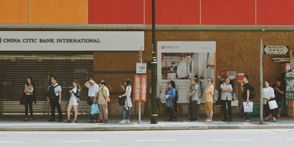 people fall inline on sidewalk