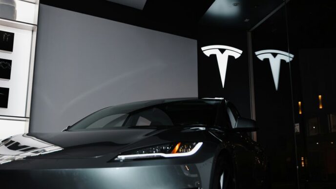 A car parked in front of a large screen