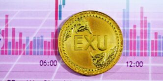 gold round coin on pink and white textile