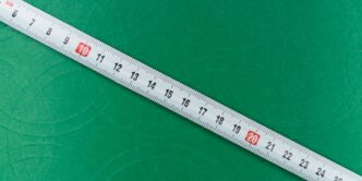 white ruler on green textile